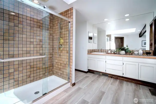Newly updated Primary Bath features a tiled shower with 2 shower sdheads