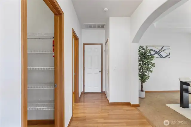 Hallway leading to walk in pantry, garage, and formal dining area