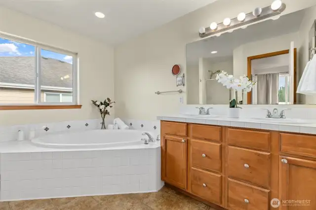 His and her sinks in addition to soaking tub