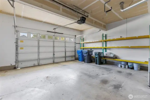 2 car garage with a workspace and shelving - both are included in sale!