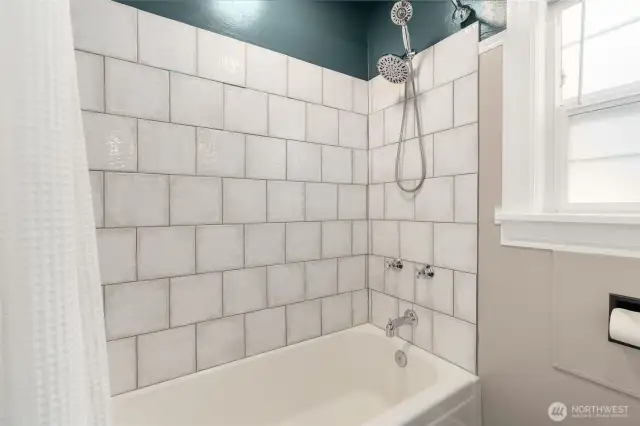 Updated Full bath on the main level has brand new tile tub surround