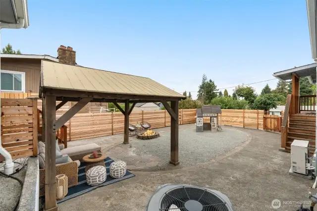 Backyard patio space is full fenced