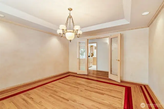 Cherry floor inlay, custom lighting & etched glass French doors.