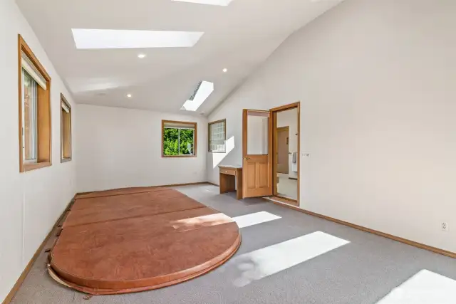 Adjacent to the primary bathroom is a large spa room, vaulted ceiling, skylights & hot tub, with plenty of room for exercise equipment, multiple skylights