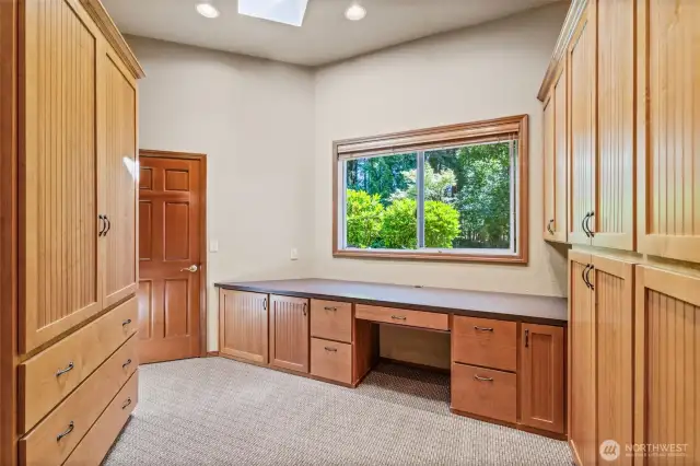 Work space, abundant shelving and behind the door is a full closet with shelving; skylights for abundant natural light.