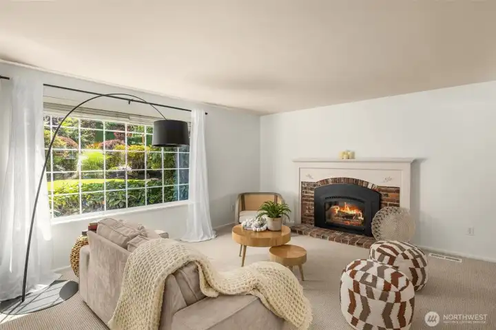 A cozy living room with fireplace offers a bright and comfortable setting for everyday relaxation.