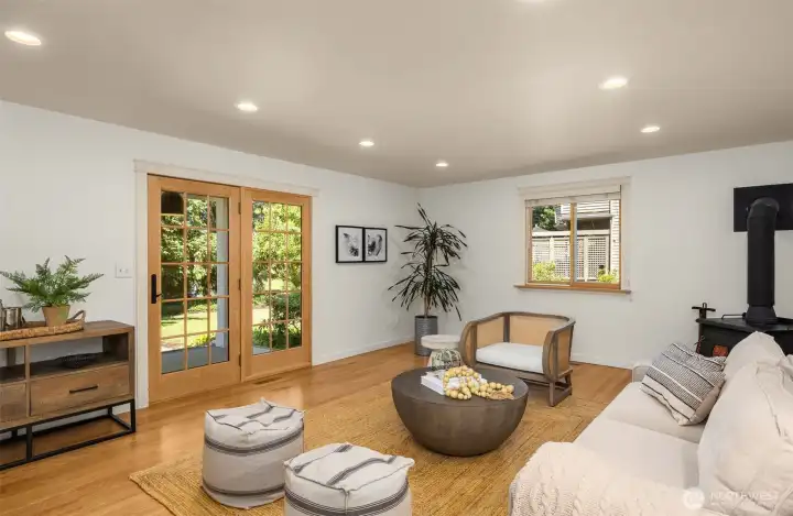 Second living room space that offers soft light filters in, creating an inviting ambiance for reading, conversation, or quiet relaxation.