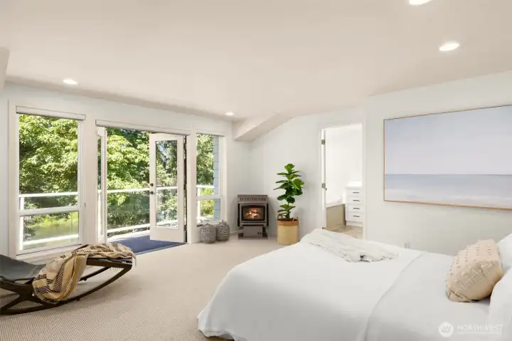 The primary bedroom is a private sanctuary with calming tones and generous windows. Natural light transforms the space into a restful haven.