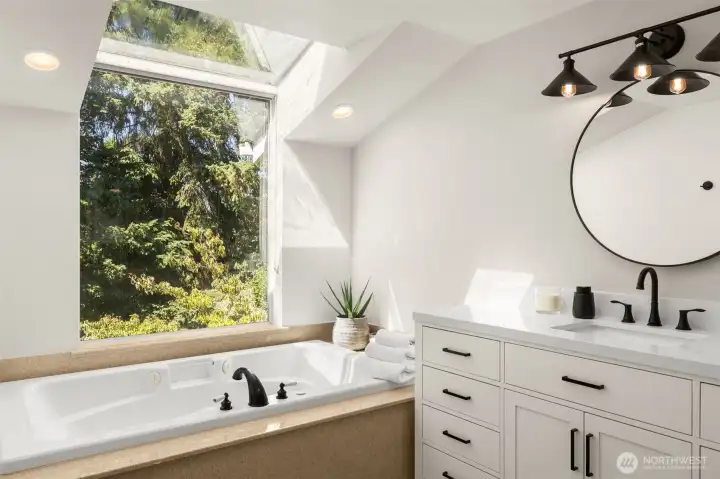 This tub sits beneath a wide window with treetop views. Perfect for spa nights where you can gaze at the stars.