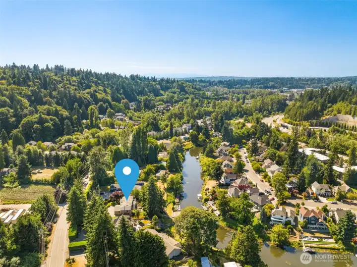 This aerial captures the rare combination of waterfront access and lush landscape. The property stretches wide, framed by natural beauty in every direction.