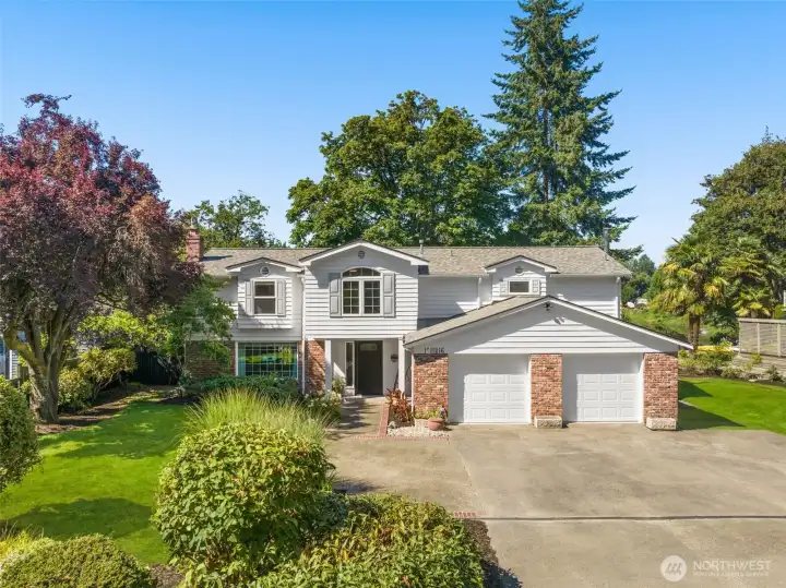 The front elevation showcases crisp siding, manicured landscaping, and a welcoming drive. Every detail reflects quality and care — this home is calling you.