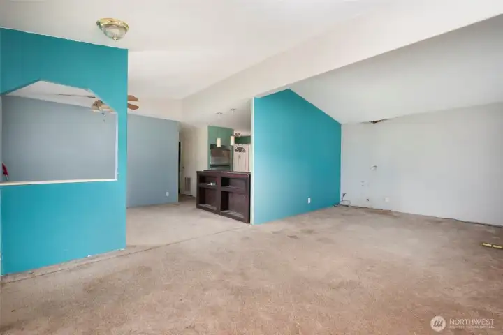 Living room opens to dining room and kitchen.