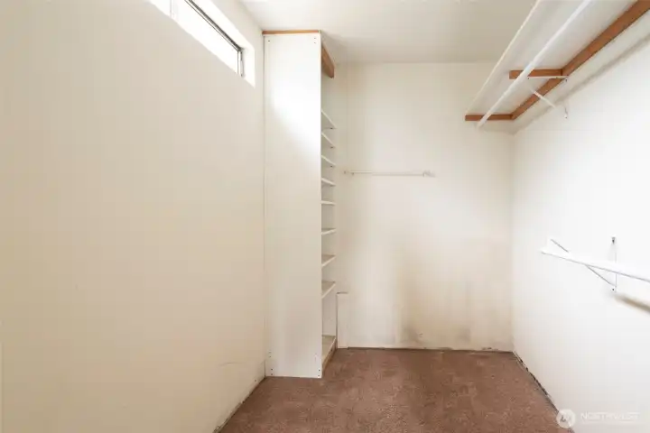 Walk in closet in primary bedroom.