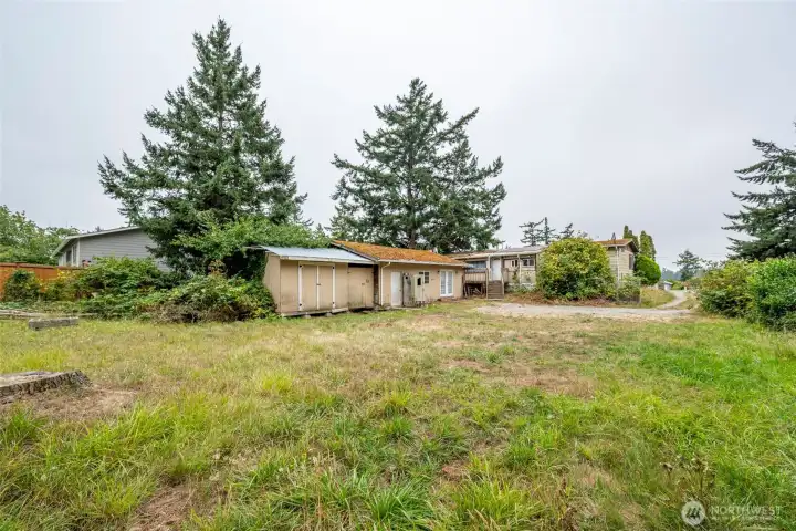 Backyard looking toward detached space and main house.