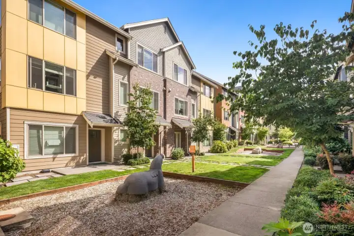 Courtyard features green space and play zones.