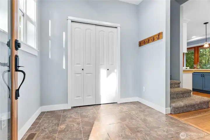 Large tile entry with nicely sized coat closet