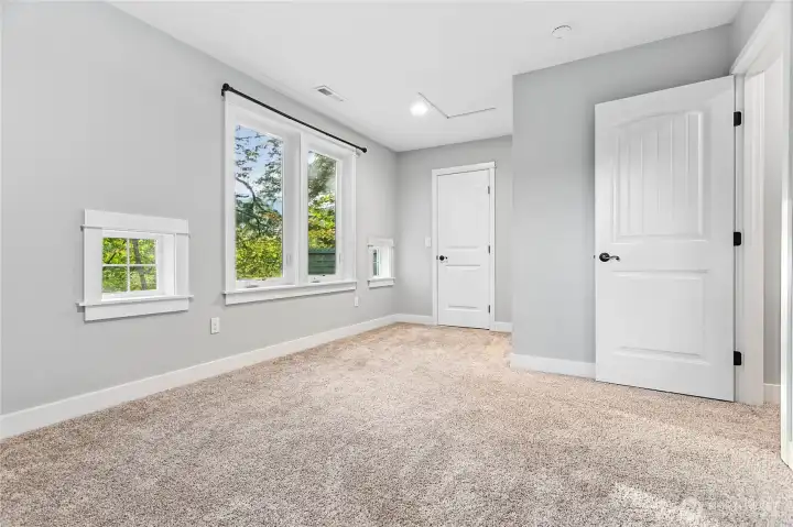 Bedroom #1 with view of walk-in closet behind door on left