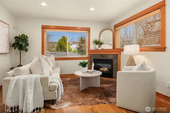Bright main-floor living room featuring a cozy gas fireplace.