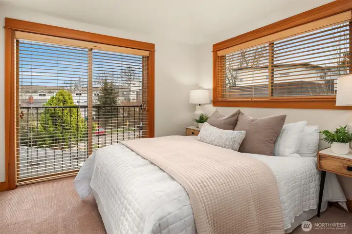 Upper-level primary bedroom with a Juliet balcony.