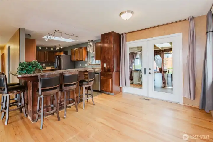 Spacious kitchen with breakfast bar seating and ample counter space.
