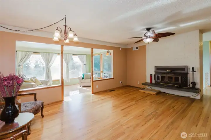 Sunroom filled with natural light, ideal for year-round enjoyment.fireplace focal point.