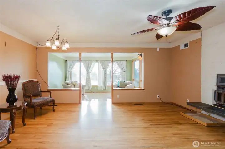 Open living and dining areas with hardwood floors and natural light.