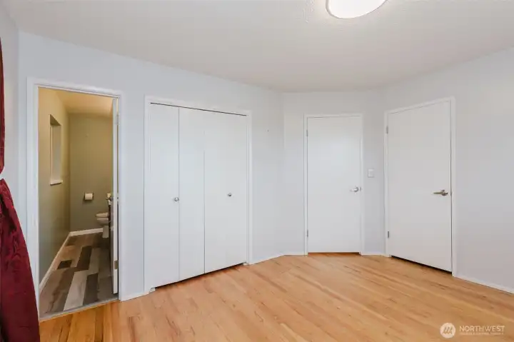 Primary bedroom with dual closets and adjoining updated half bath.