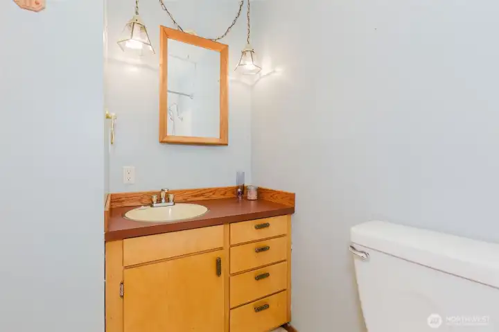 Main bathroom with single vanity and updated lighting.