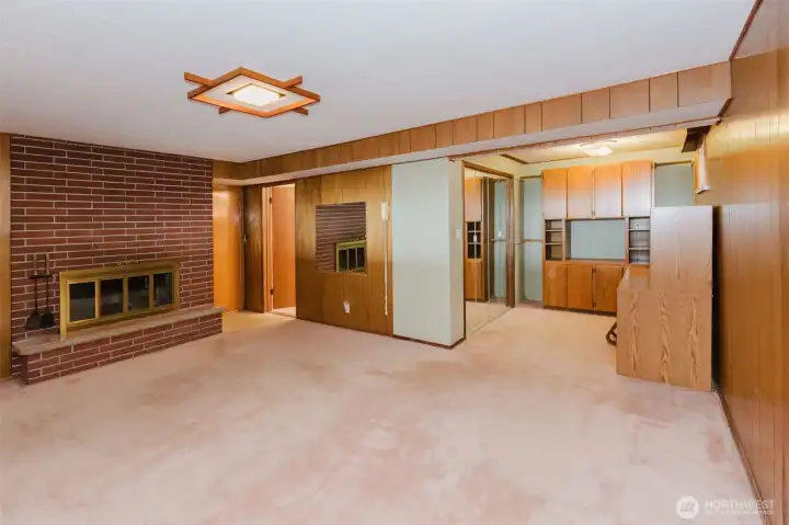 Spacious lower-level bonus room with fireplace and built-in storage.