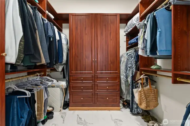 Primary Walk-in Closet w/ custom built-ins and new floors