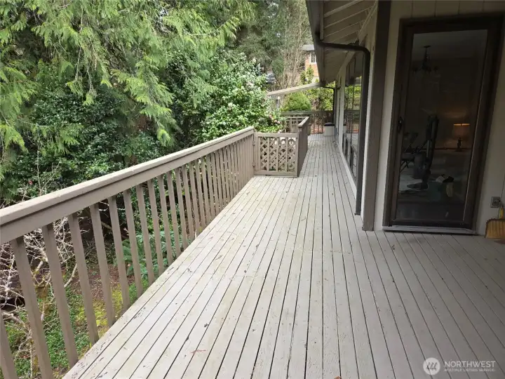 The deck runs the back of the house to the primary bedroom deck