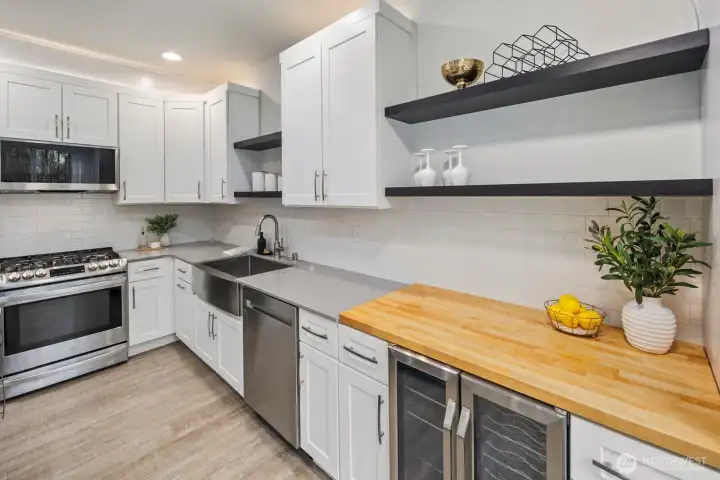 Kitchen has a dedicated butcher block top and wine fridge below