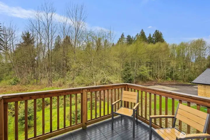 Deck off the main living area on main floor backs to a greenbelt for added privacy
