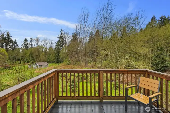 Deck off the main living area on main floor backs to a greenbelt for added privacy