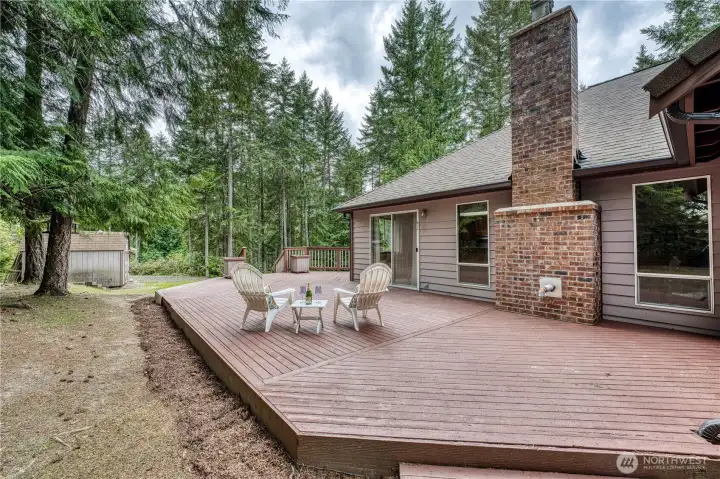 large deck with private backyard