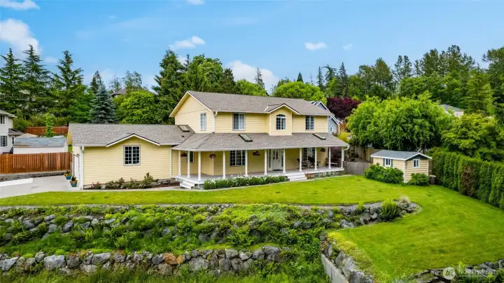 Fresh exterior paint and a wrap-around covered porch add to the charm of this impressive home.