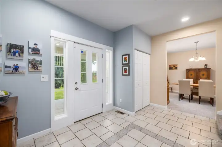 The gracious foyer features tiled floor, plenty of room for greeting your guests, and immediate access both to the formal dining room and the ample living area.