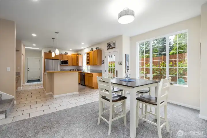 Just off the living area is this spacious breakfast area, with east-facing windows for morning light, plenty of room for casual dining, and is open to the kitchen.