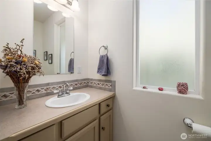 Powder room 1/2 bath on the main floor.  Tile floor and backsplash.