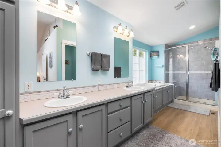 Primary ensuite bathroom - tons of storage along this double vanity.  Soaking tub and tiled shower.