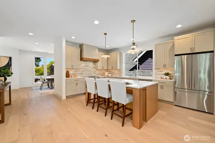 Iron Chef grade kitchen features a 4x8-foot quartz island, custom cabinets by Huntwood, Fisher Paykel appliances and induction range.