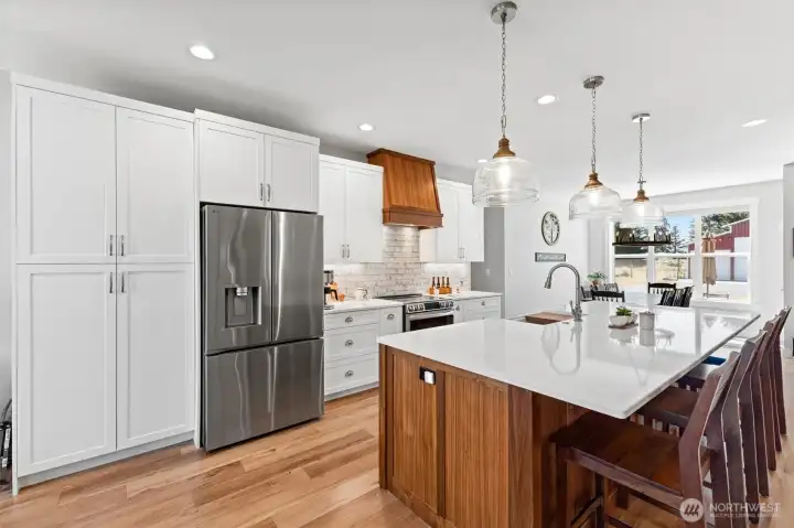 Redesigned kitchen. Custom cabinetry with soft-close doors and drawers. Pantry built into the kitchen area.