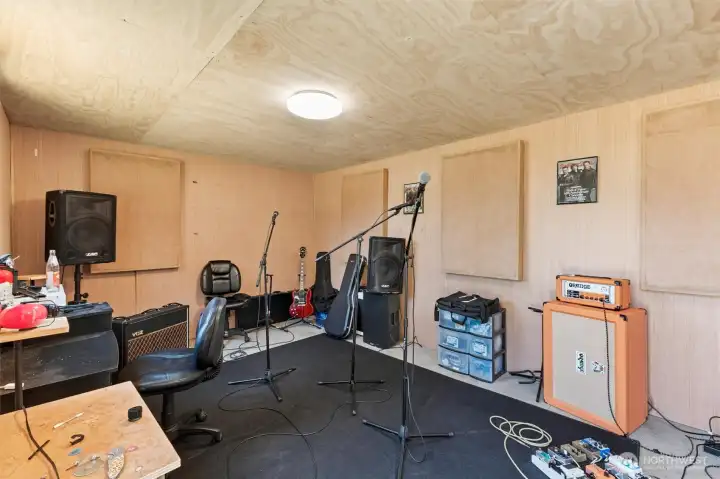 Shop area small room could be a wood shop area or stay as a sound proof room.
