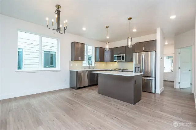 All Design Packages include stunning quartz counters with full tile backsplash, luxury vinyl plank flooring & striking contemporary lighting & hardware. Note the eat-in island, contrasting upper & lower cabinetry colors, under cabinet lighting and large energy efficient windows.