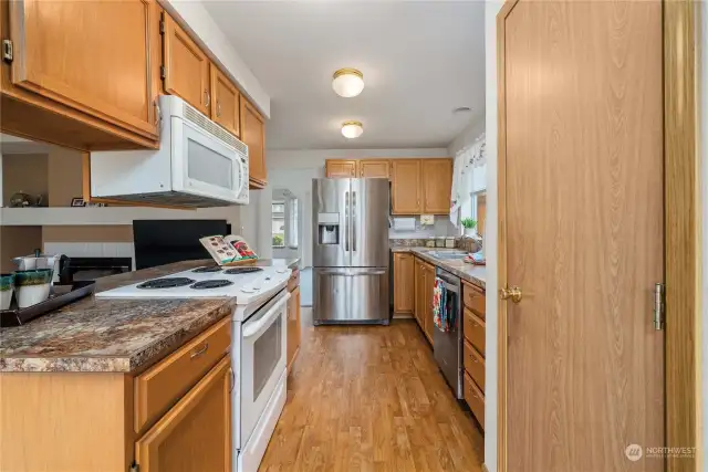 Efficient kitchen design with plenty of counter space and cabinets, as well as a large pantry.