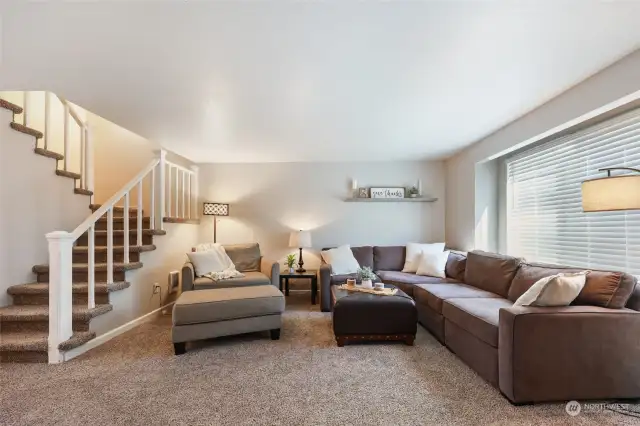 This sectional and "chair-and-a-half" fit easily in the space! Stairs lead to the bedrooms.