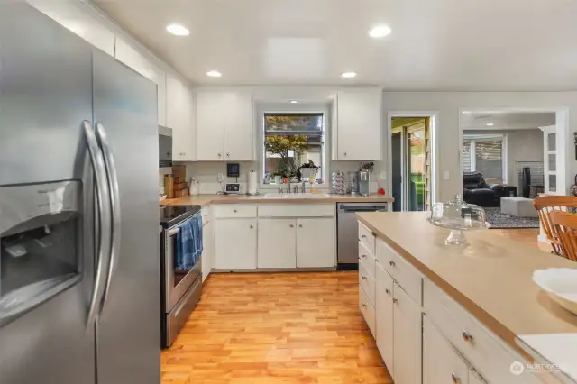 Kitchen receives an abundance of light and offers ample storage and counter space.