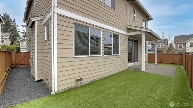 The backyard is fully fenced perfect for playing and game.  The backyard has a modern synthetic grass.  A very usefull shed room covers most of the patio from rain and snow.