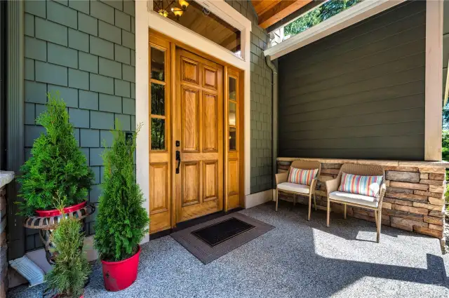Beautiful front porch entry with a gorgeous Craftsman door.