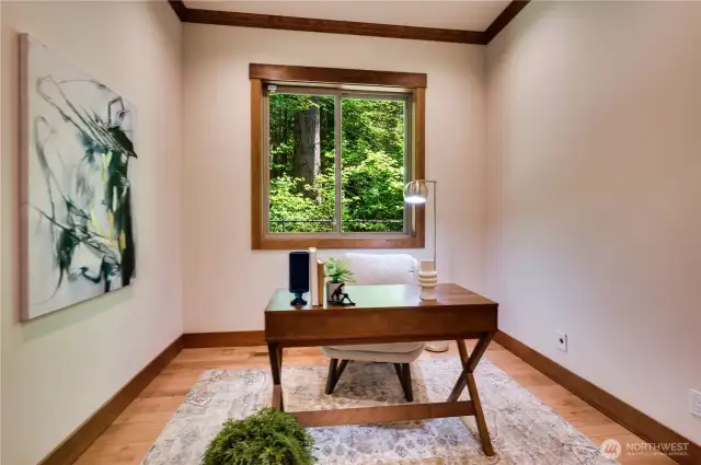 Downstairs den with wooded views.